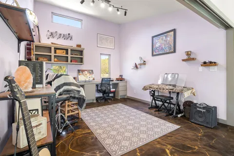 a bed sitting in a bedroom next to a window