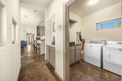 a spacious bedroom with a bed and a dresser