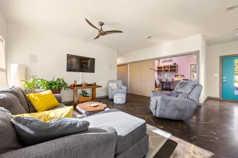 a large kitchen with a table and chairs