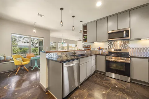 a view of a kitchen with appliances and cabinets