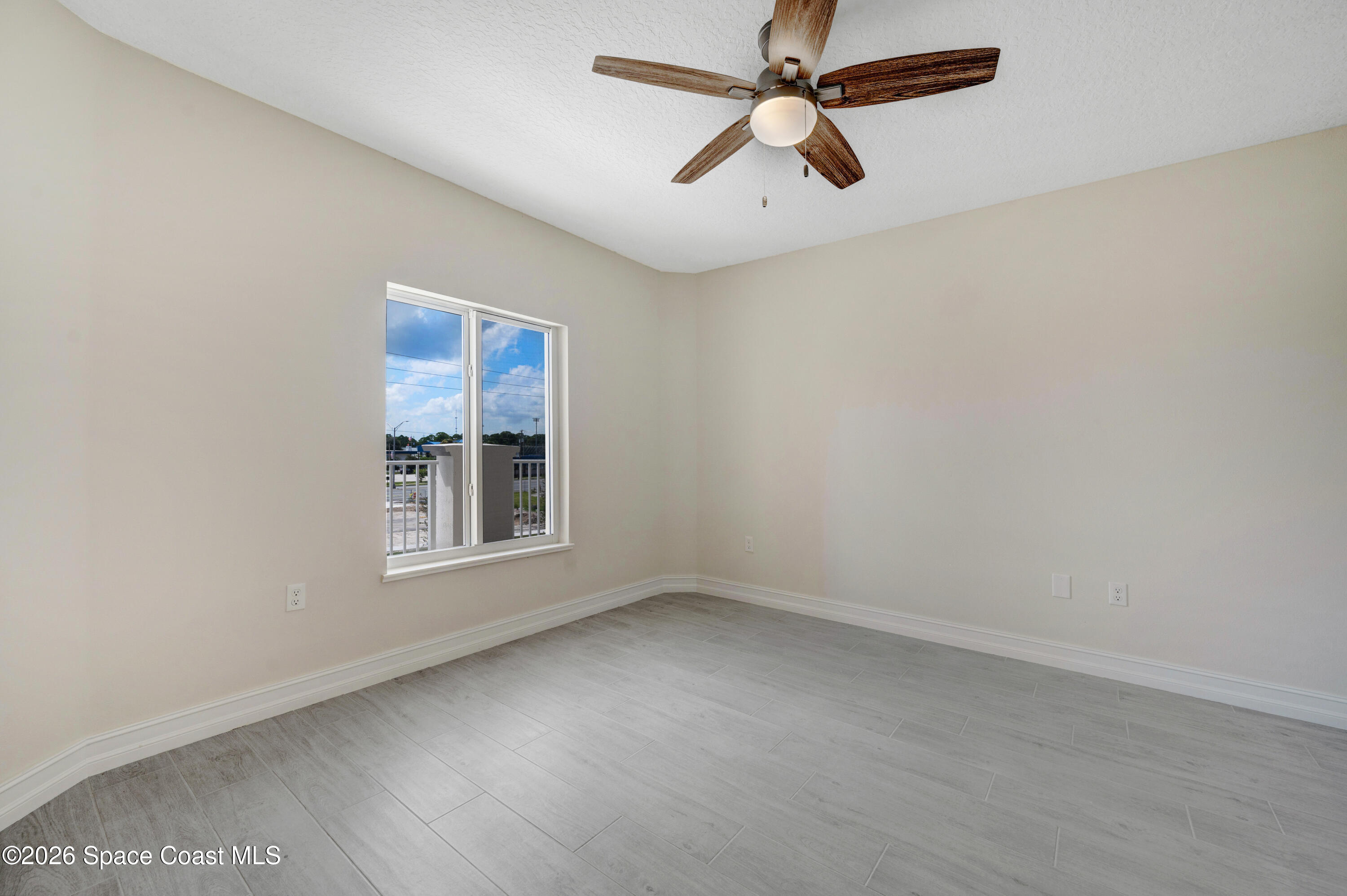 1805 Riverside Drive, Unit 304 Titusville, FL 32780 - Photo 20 of 46 an empty room with a window and a fan