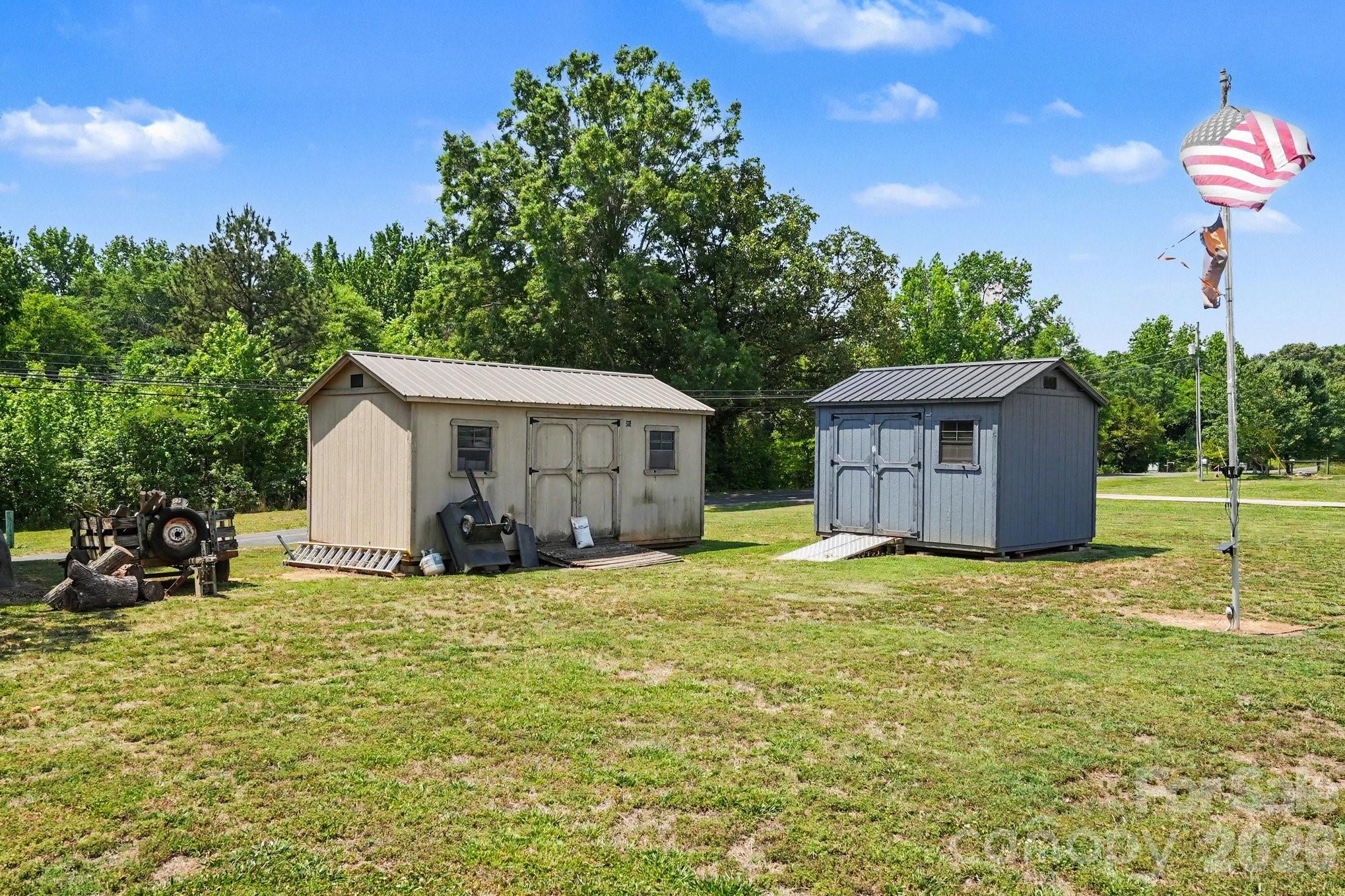 24359 Ridgecrest Road Locust, NC 28097 - Photo 23 of 26 a view of a house with a yard and sitting area