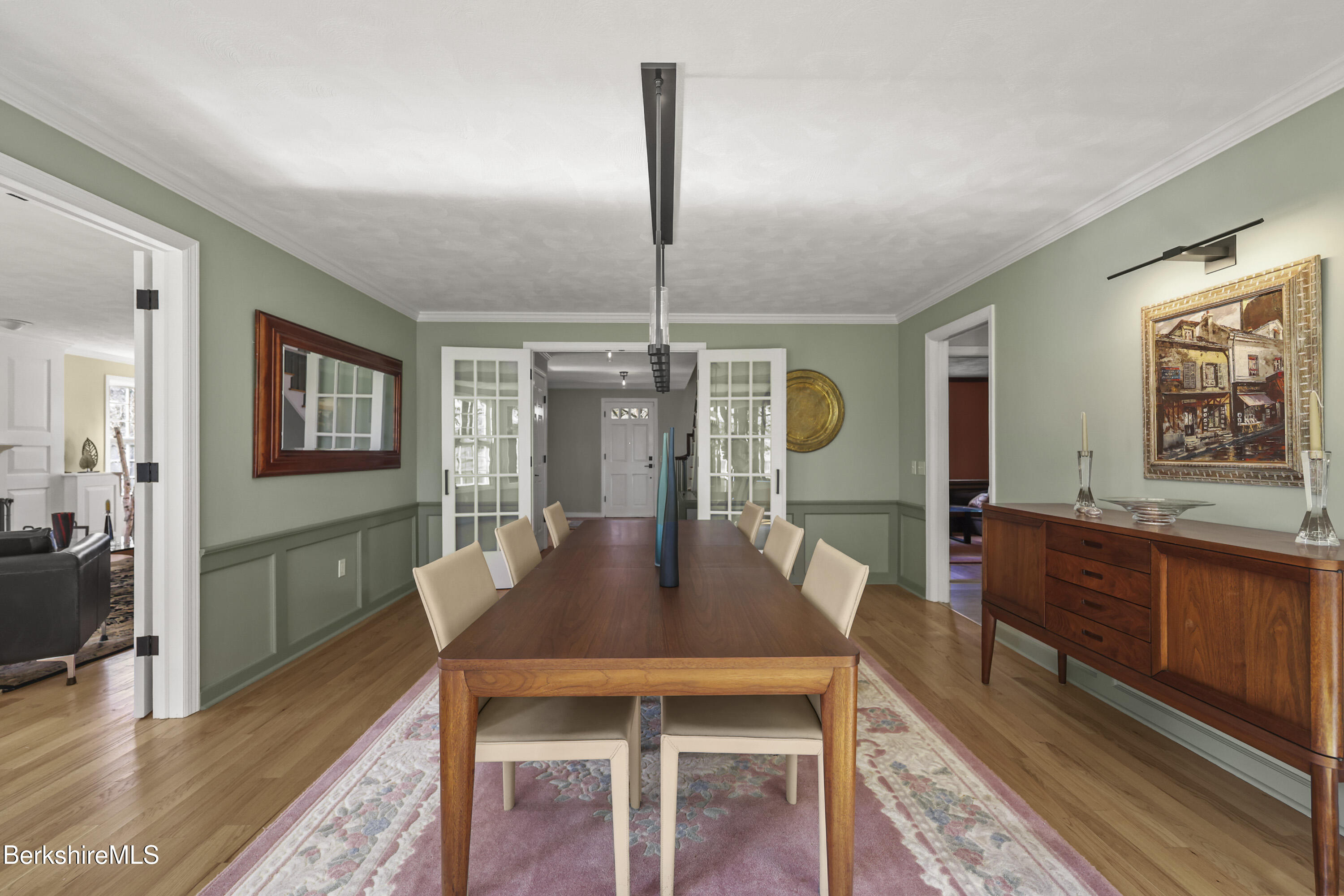69 Gravesleigh Terrace Pittsfield, MA 01201 - Photo 26 of 84 a dining room with wooden floor a chandelier a wooden table and chairs