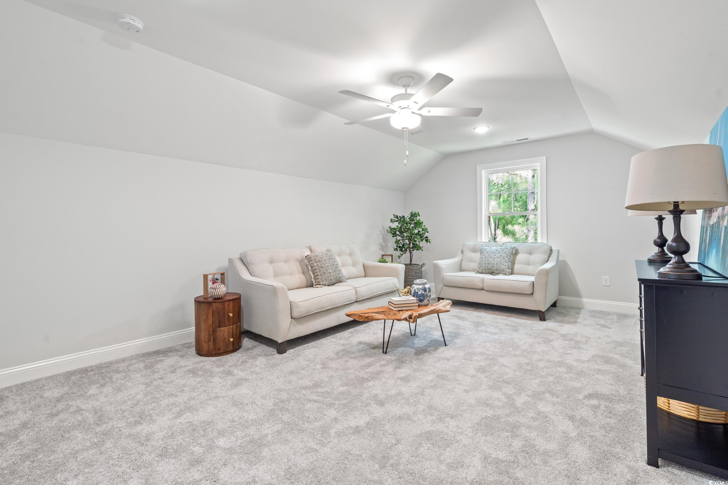 852 Commanders Island Road Georgetown, SC 29440 - Photo 14 of 37 Carpeted living area with lofted ceiling, baseboards, and a ceiling fan