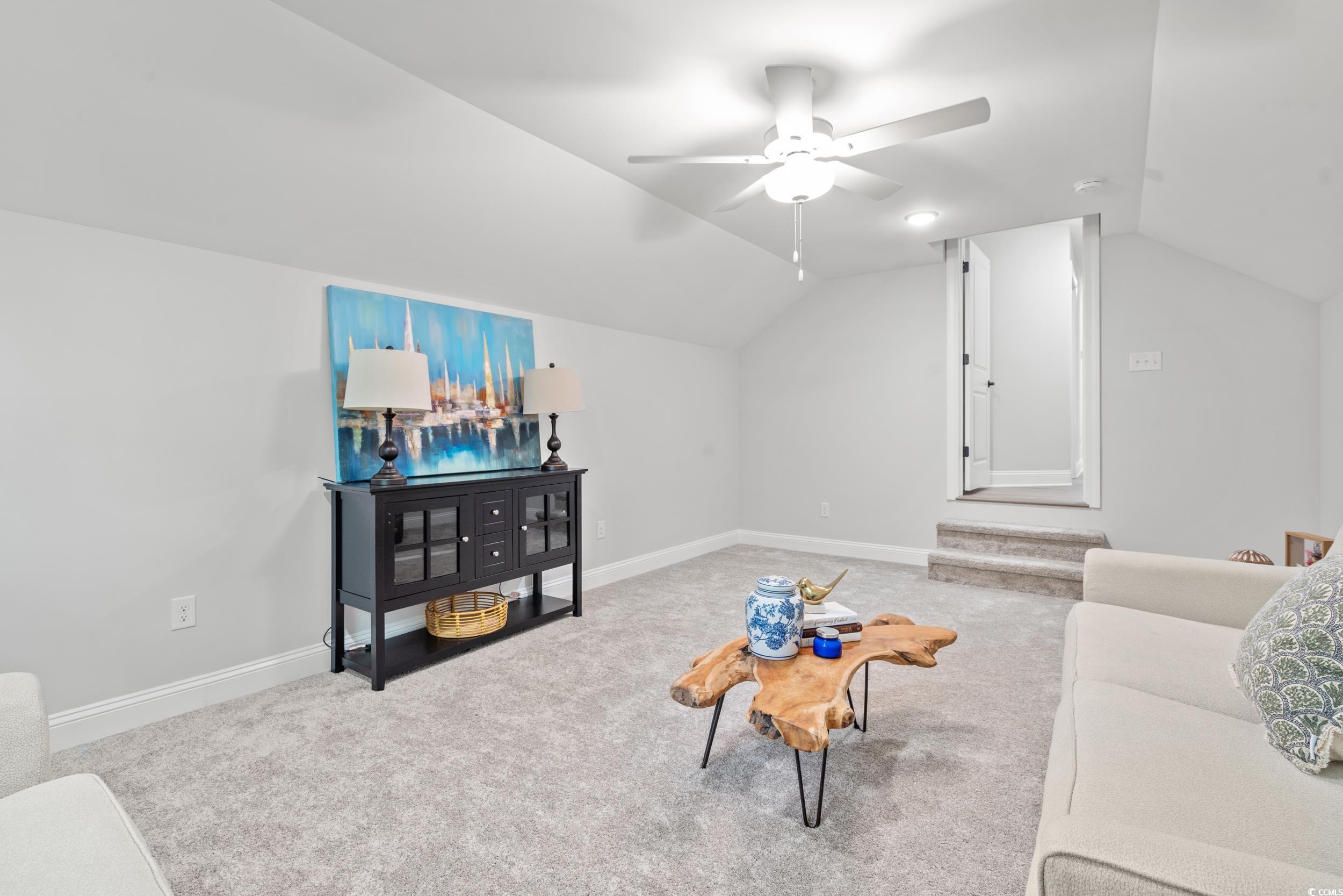 852 Commanders Island Road Georgetown, SC 29440 - Photo 19 of 37 Carpeted living area featuring vaulted ceiling, a ceiling fan, and baseboards