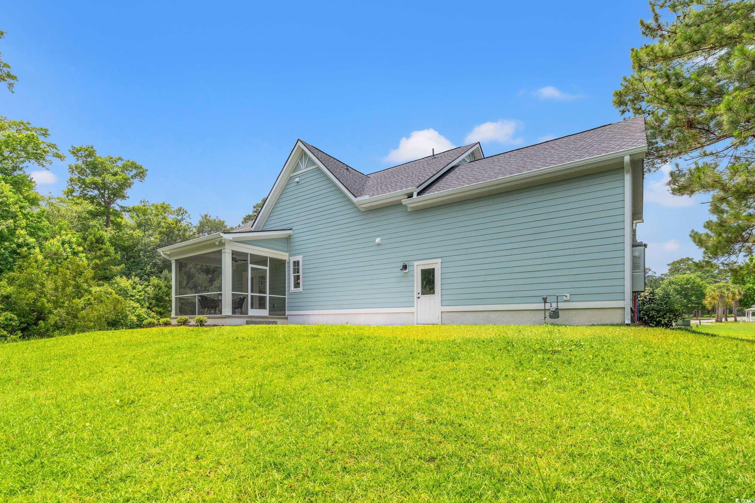 852 Commanders Island Road Georgetown, SC 29440 - Photo 20 of 37 Rear view of house featuring a sunroom, a yard, and roof with shingles