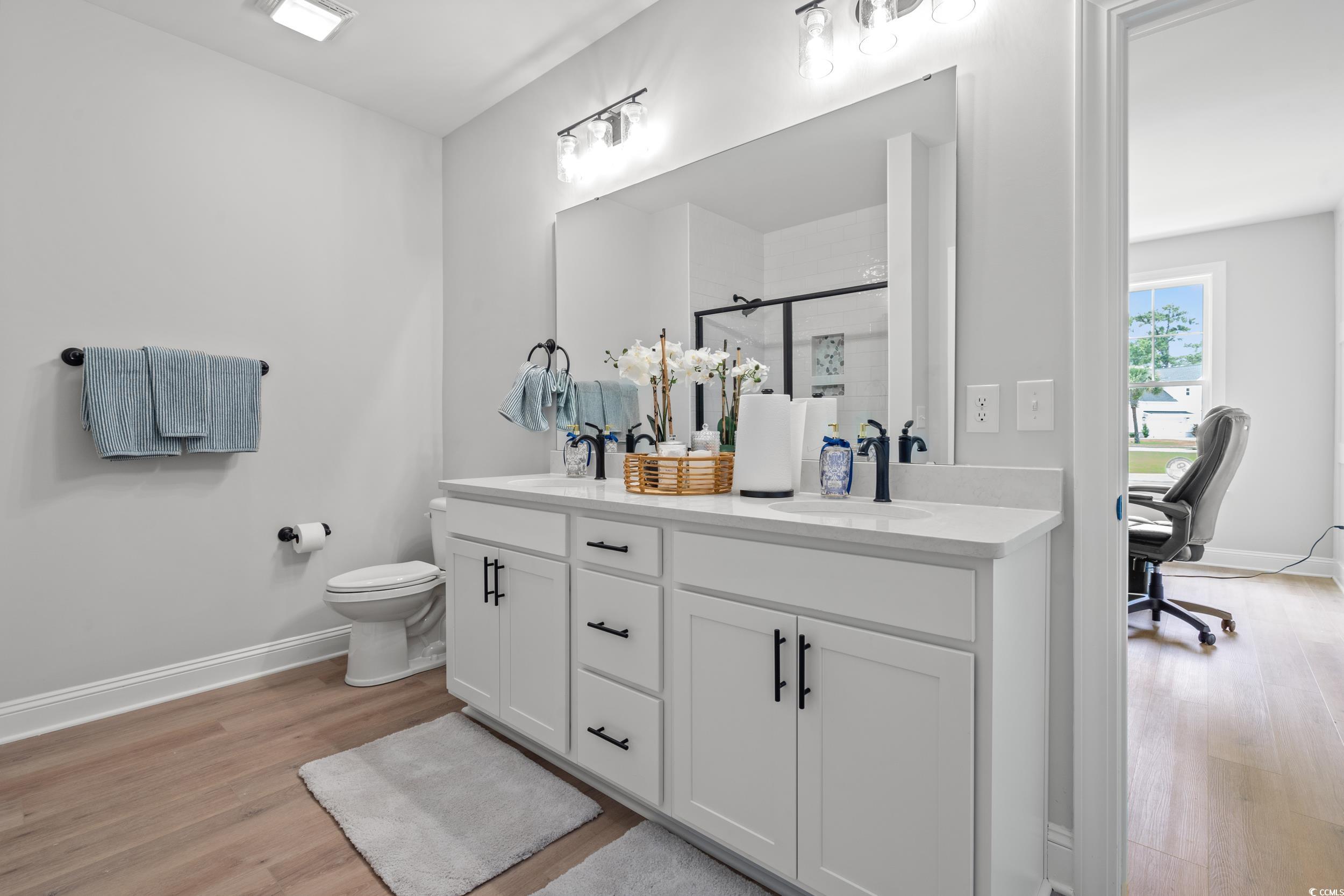 852 Commanders Island Road Georgetown, SC 29440 - Photo 10 of 37 Full bath featuring wood finished floors, double vanity, a shower stall, and baseboards