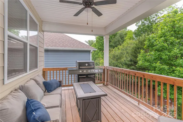 a view of a patio with a table chairs and a floor to ceiling window