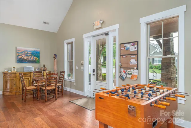 a kitchen with stainless steel appliances a stove a sink and a dining table
