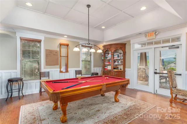 a room with pool table and windows