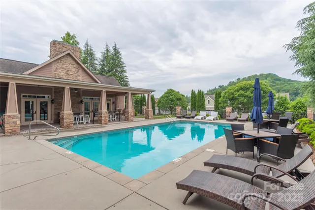 a view of house with swimming pool having outdoor seating