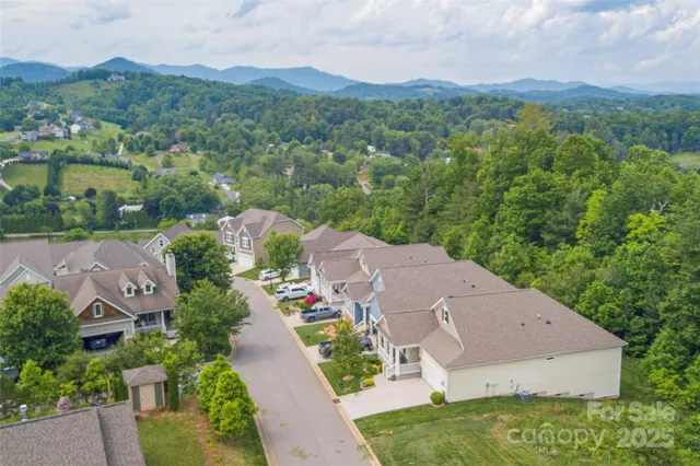 an aerial view of a house with yard