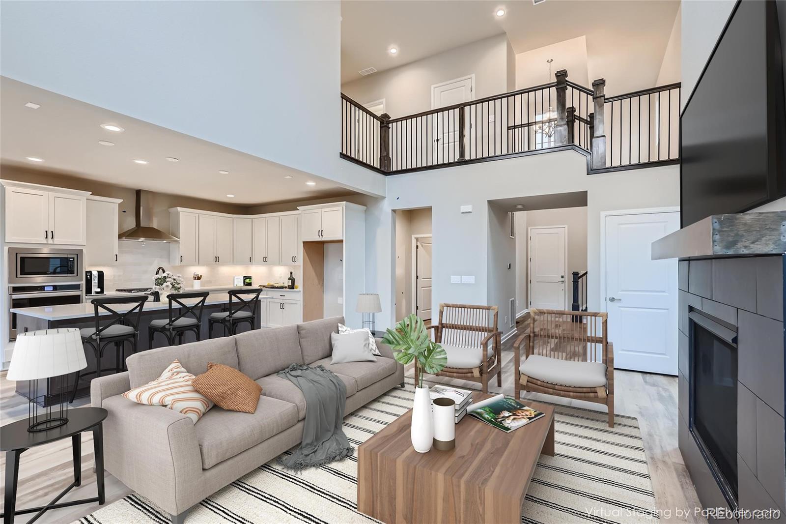 624 Simmental Loop Castle Rock, CO 80104 - Photo 2 of 9 a living room with furniture a fireplace and kitchen view