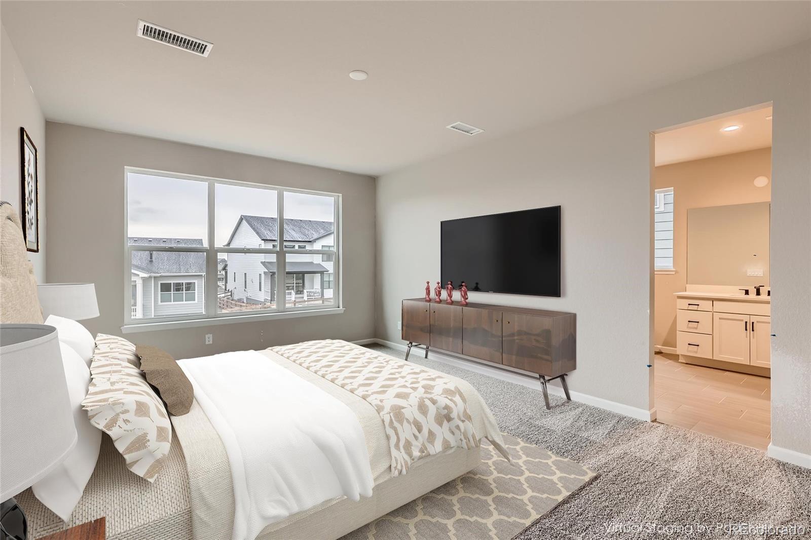 624 Simmental Loop Castle Rock, CO 80104 - Photo 5 of 9 a bedroom with a bed and a flat screen tv