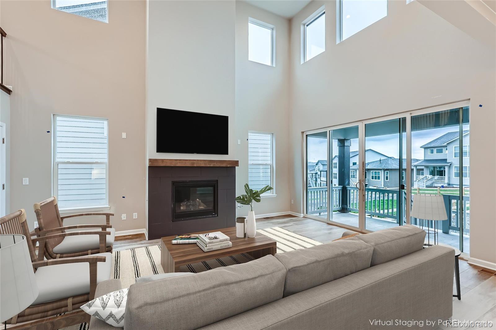 624 Simmental Loop Castle Rock, CO 80104 - Photo 6 of 9 a living room with furniture a fireplace and a flat screen tv