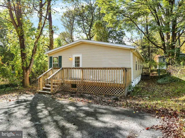 a view of a house with a yard and fence