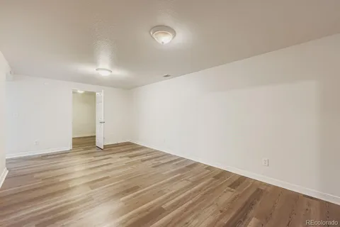 a view of an empty room with wooden floor