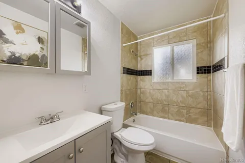 a bathroom with a sink mirror toilet and bathtub