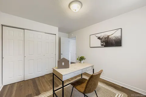 a workspace room with furniture and wooden floor