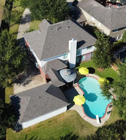 an aerial view of a house with yard and parking