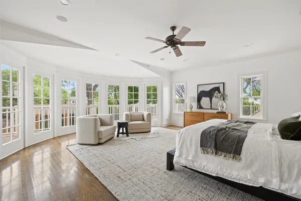 a bedroom with a large bed couch and a window
