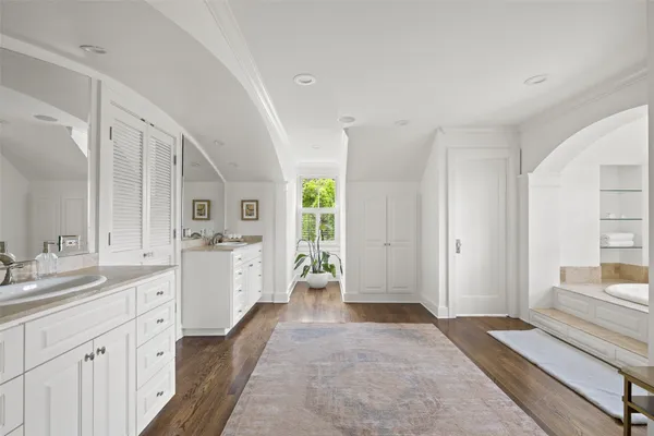 a large white kitchen with a large window