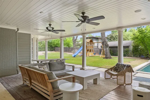 a living room with patio furniture and garden view