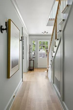an empty room with windows and stairs