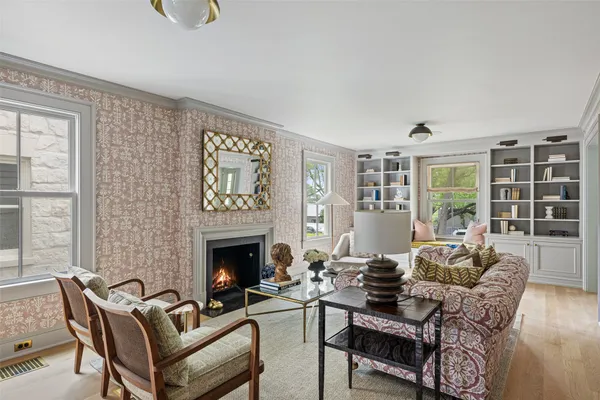 a living room with furniture fireplace and window