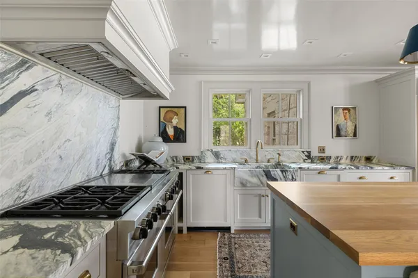 a kitchen with a stove a sink and a refrigerator