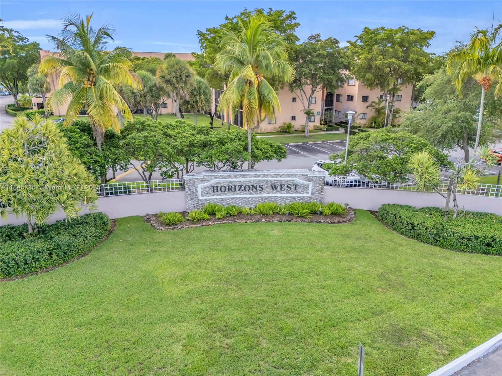 8760 Southwest 133rd Avenue Road, Unit 108 Miami, FL 33183 - Photo 11 of 39 a view of a garden with a building in the background
