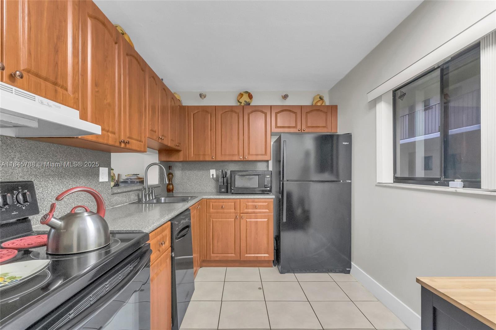8760 Southwest 133rd Avenue Road, Unit 108 Miami, FL 33183 - Photo 20 of 39 a kitchen with stainless steel appliances granite countertop a refrigerator and a sink