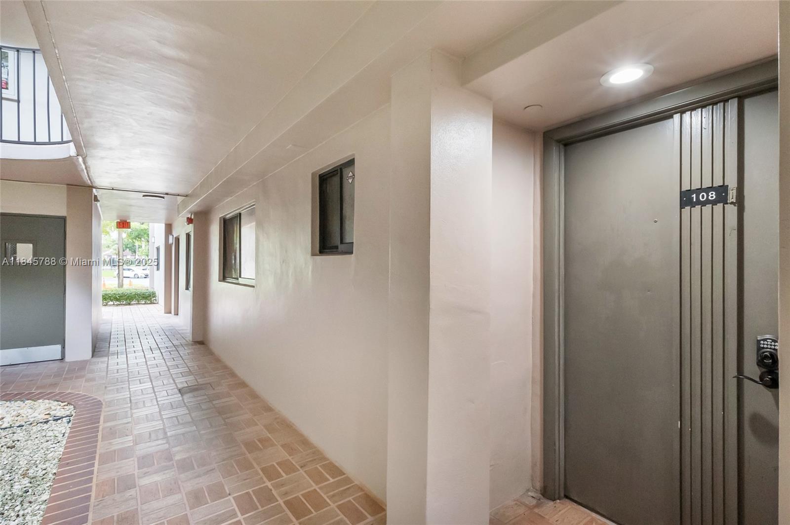 8760 Southwest 133rd Avenue Road, Unit 108 Miami, FL 33183 - Photo 2 of 39 a view of hallway with livingroom