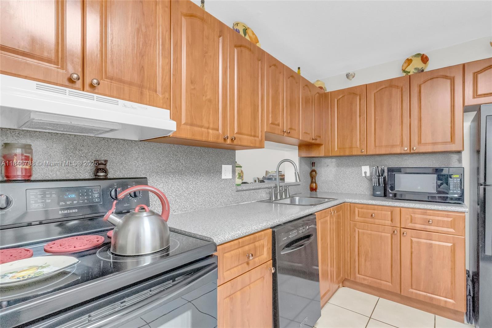 8760 Southwest 133rd Avenue Road, Unit 108 Miami, FL 33183 - Photo 21 of 39 a kitchen with a sink and cabinets