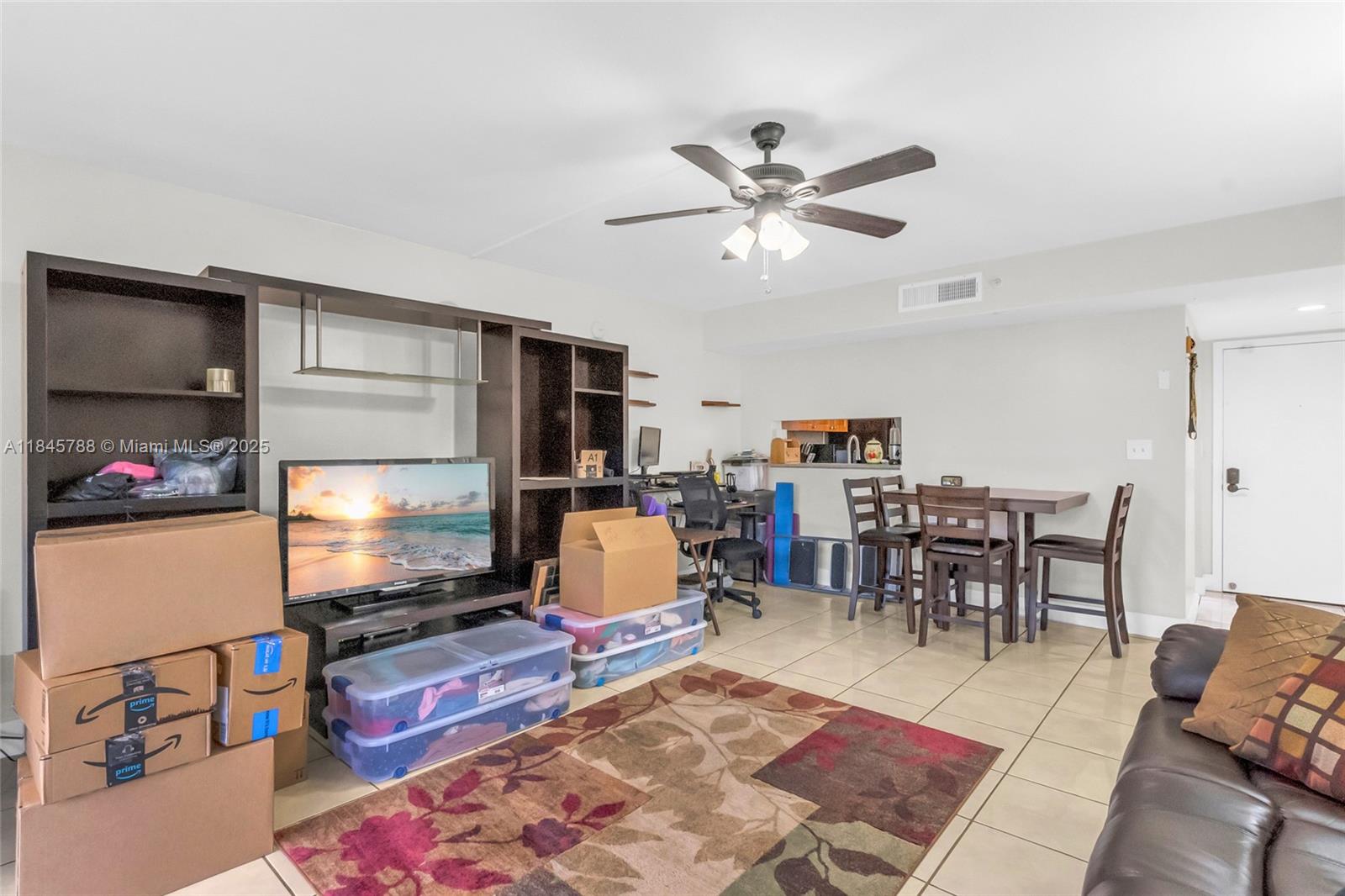 8760 Southwest 133rd Avenue Road, Unit 108 Miami, FL 33183 - Photo 25 of 39 a living room with furniture and a flat screen tv