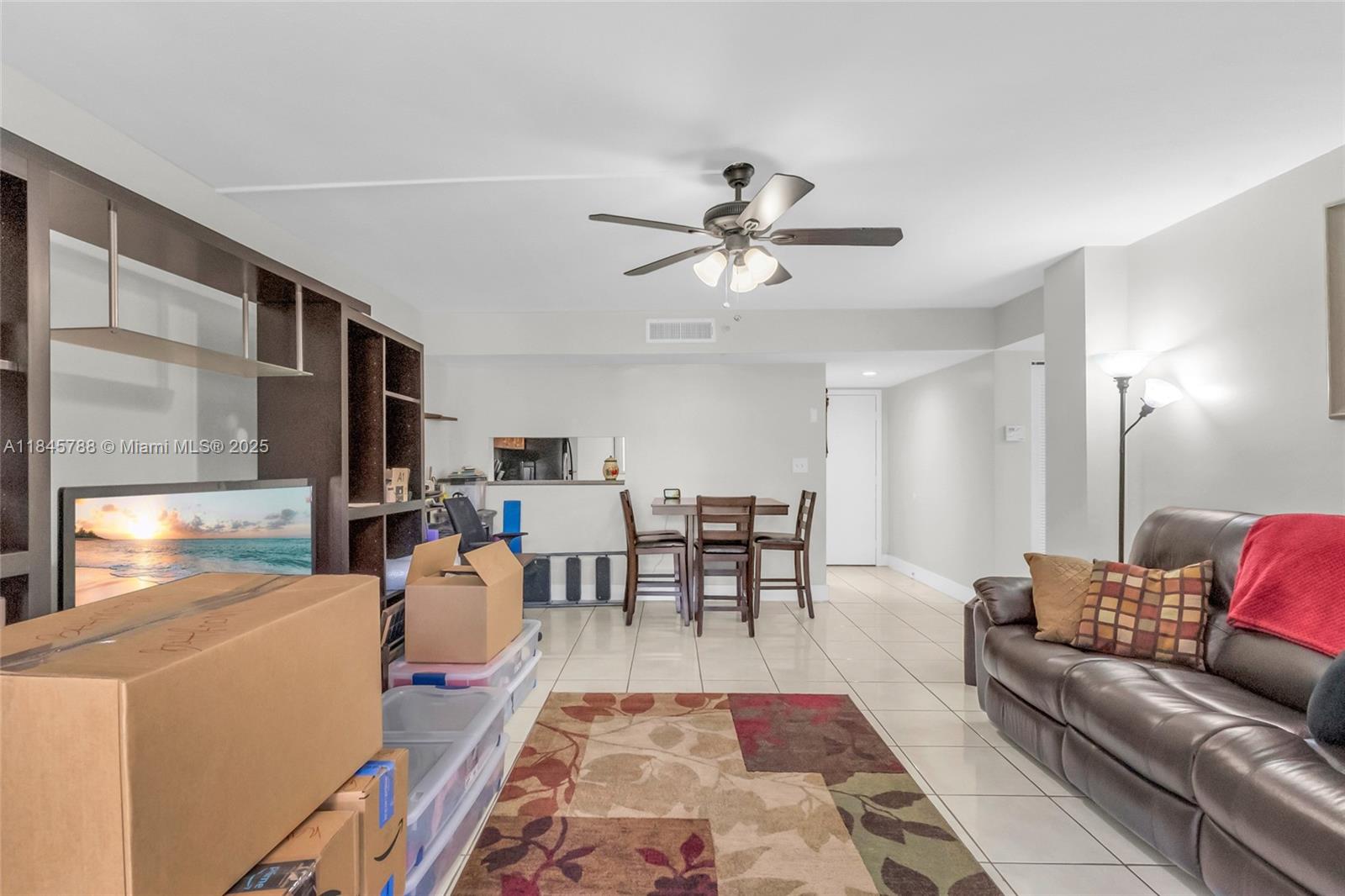 8760 Southwest 133rd Avenue Road, Unit 108 Miami, FL 33183 - Photo 26 of 39 a living room with furniture a flat screen tv and a table