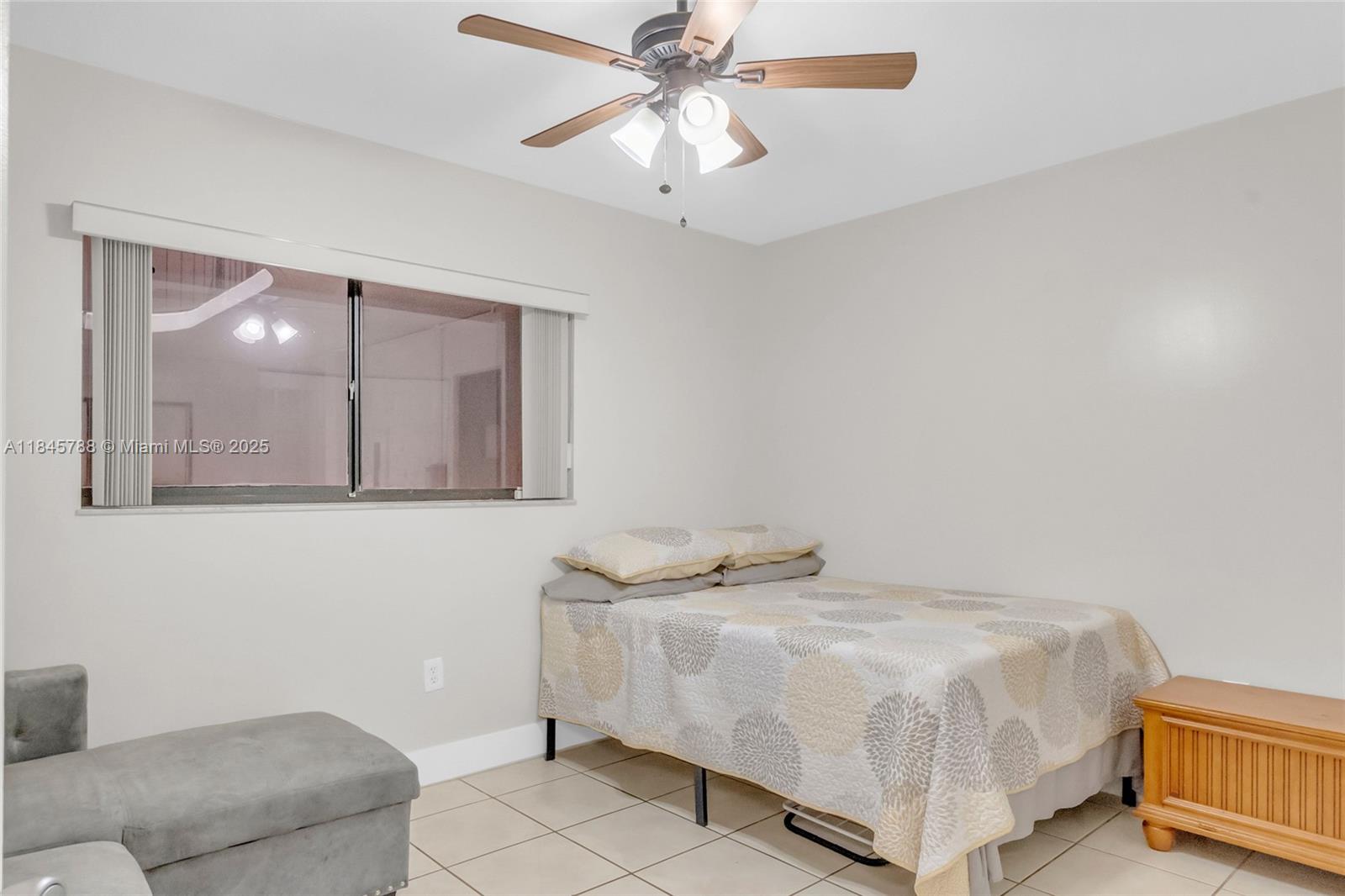 8760 Southwest 133rd Avenue Road, Unit 108 Miami, FL 33183 - Photo 27 of 39 a bedroom with a bed and a couch