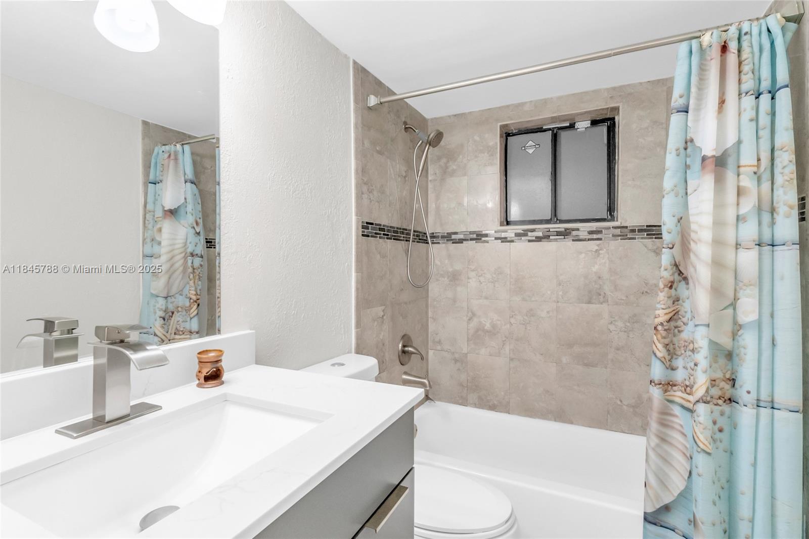 8760 Southwest 133rd Avenue Road, Unit 108 Miami, FL 33183 - Photo 29 of 39 a bathroom with a sink a toilet and shower