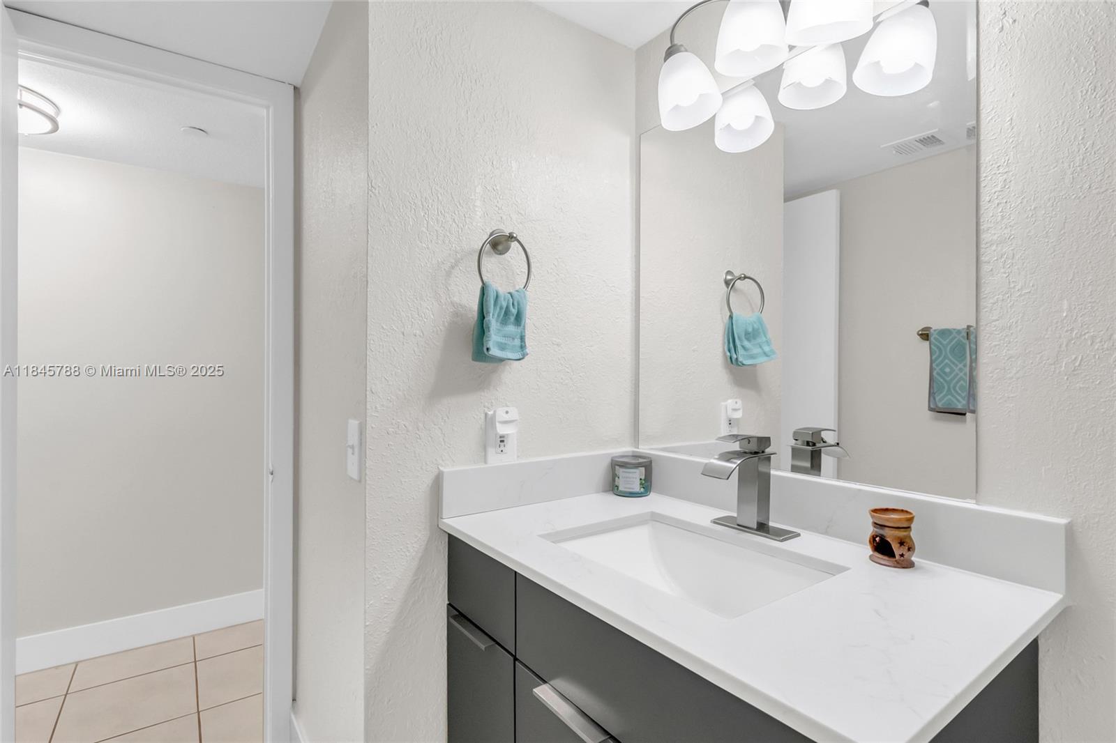 8760 Southwest 133rd Avenue Road, Unit 108 Miami, FL 33183 - Photo 30 of 39 a bathroom with a sink and a mirror