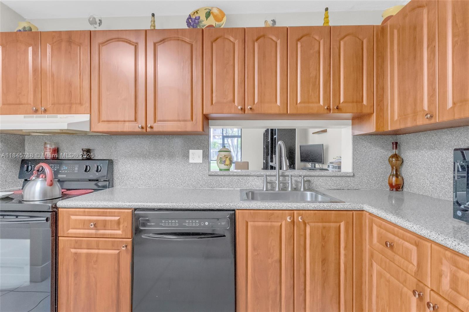 8760 Southwest 133rd Avenue Road, Unit 108 Miami, FL 33183 - Photo 3 of 39 a kitchen with stainless steel appliances granite countertop a sink and dishwasher with cabinets