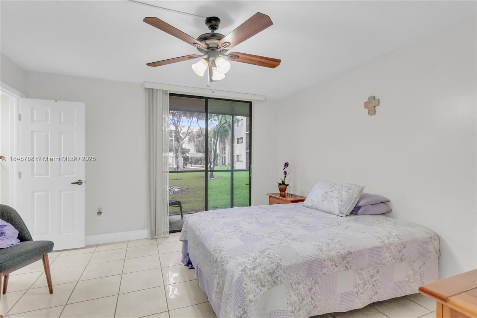 8760 Southwest 133rd Avenue Road, Unit 108 Miami, FL 33183 - Photo 31 of 39 a bedroom with a large bed and a window