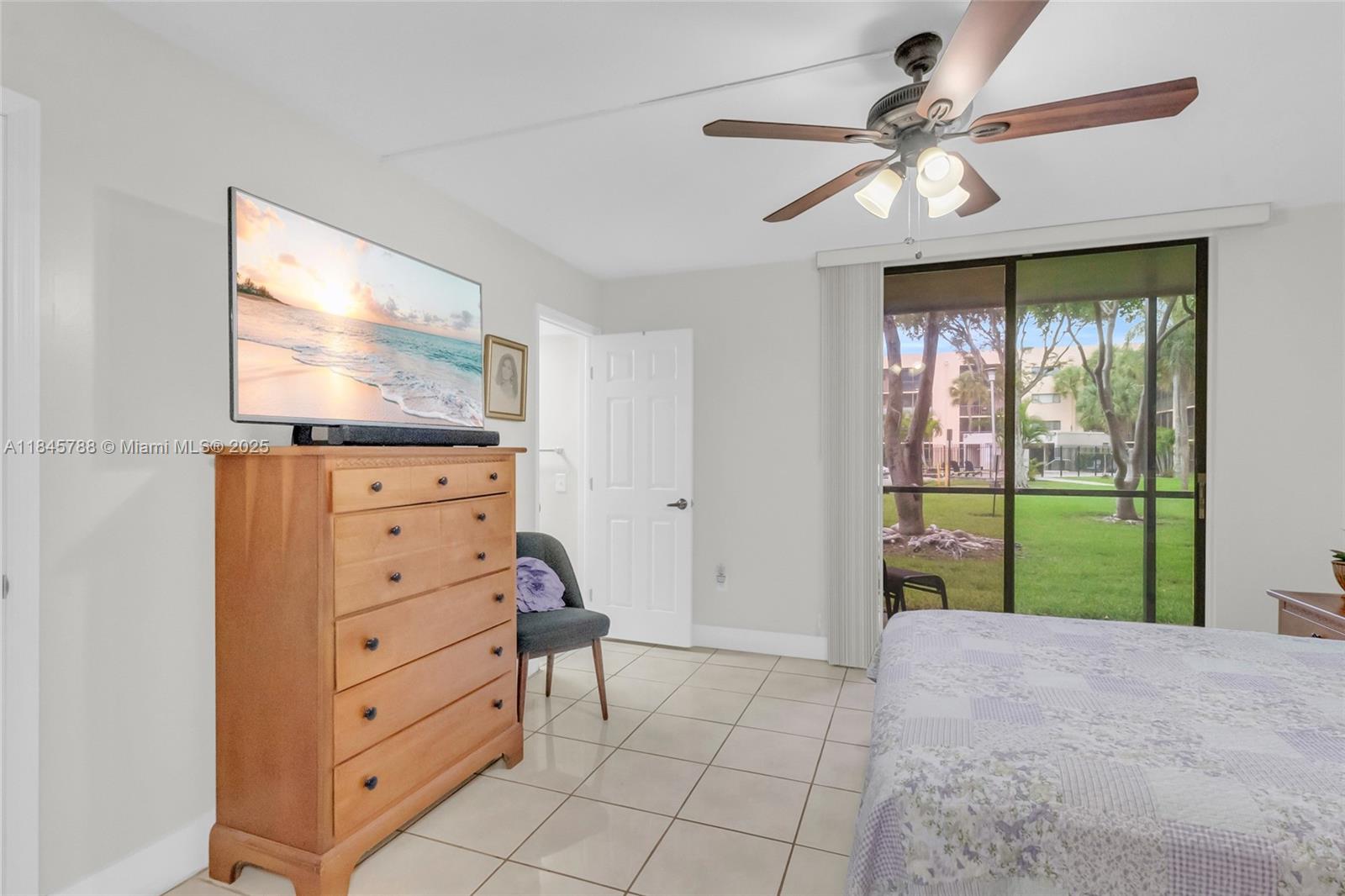 8760 Southwest 133rd Avenue Road, Unit 108 Miami, FL 33183 - Photo 32 of 39 a bed room with a bed and a television