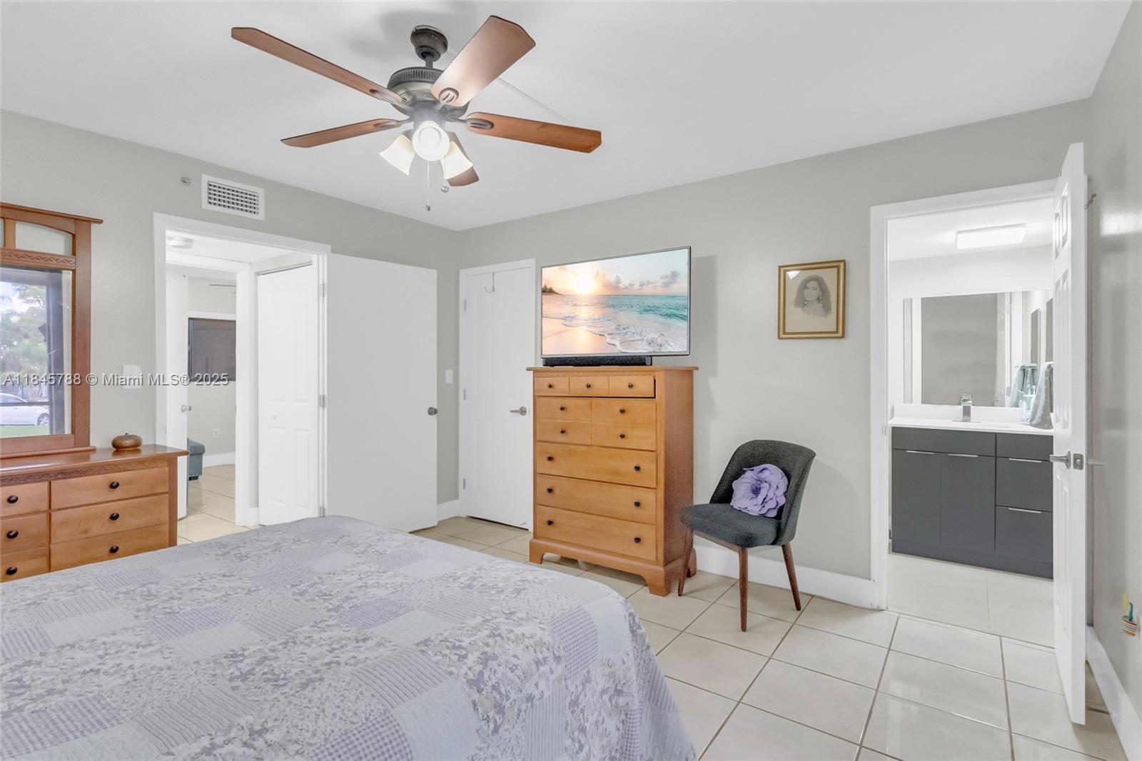 8760 Southwest 133rd Avenue Road, Unit 108 Miami, FL 33183 - Photo 33 of 39 a bedroom with a bed a dresser and chair