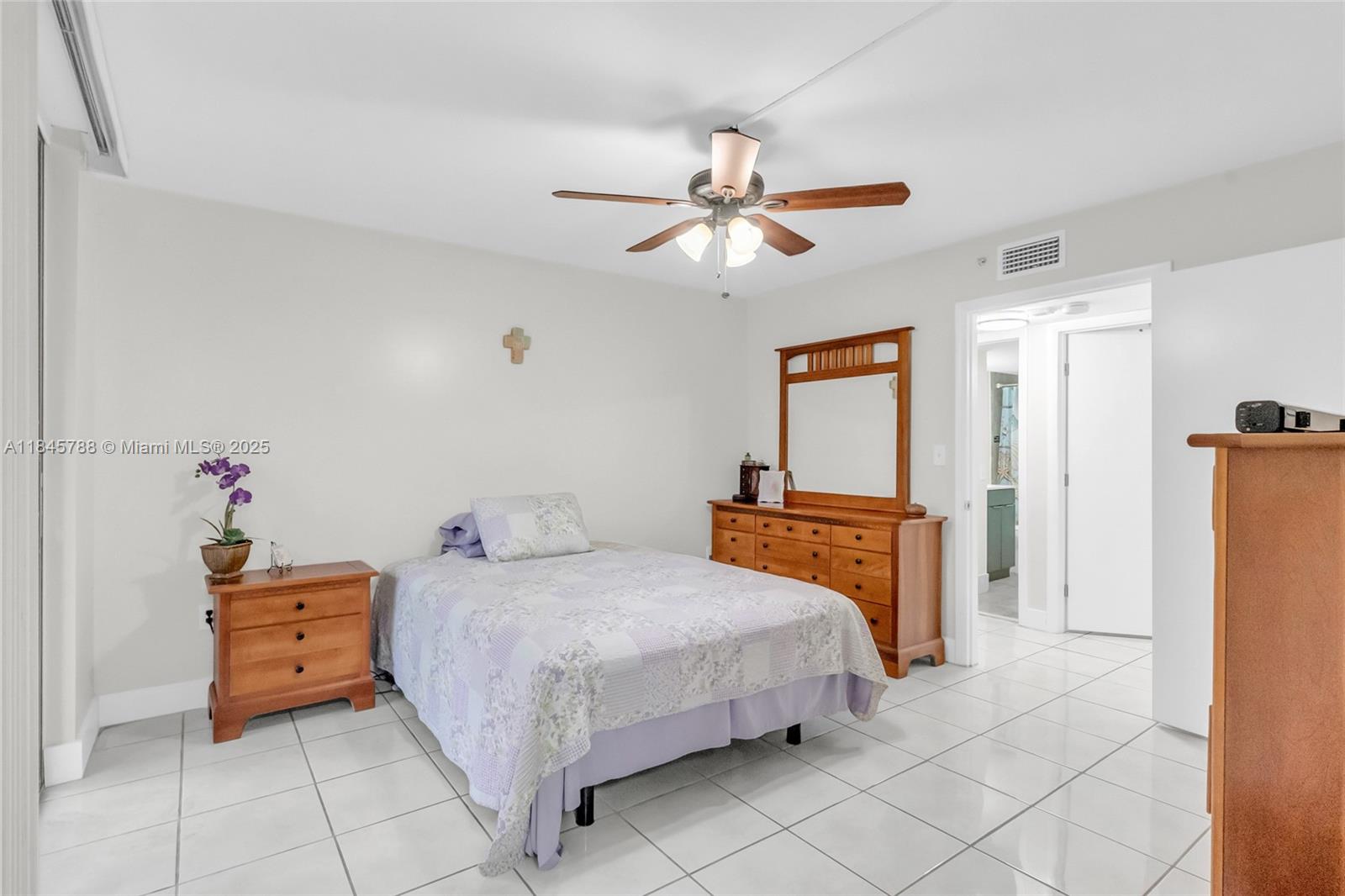 8760 Southwest 133rd Avenue Road, Unit 108 Miami, FL 33183 - Photo 34 of 39 a bedroom with a bed and a chandelier