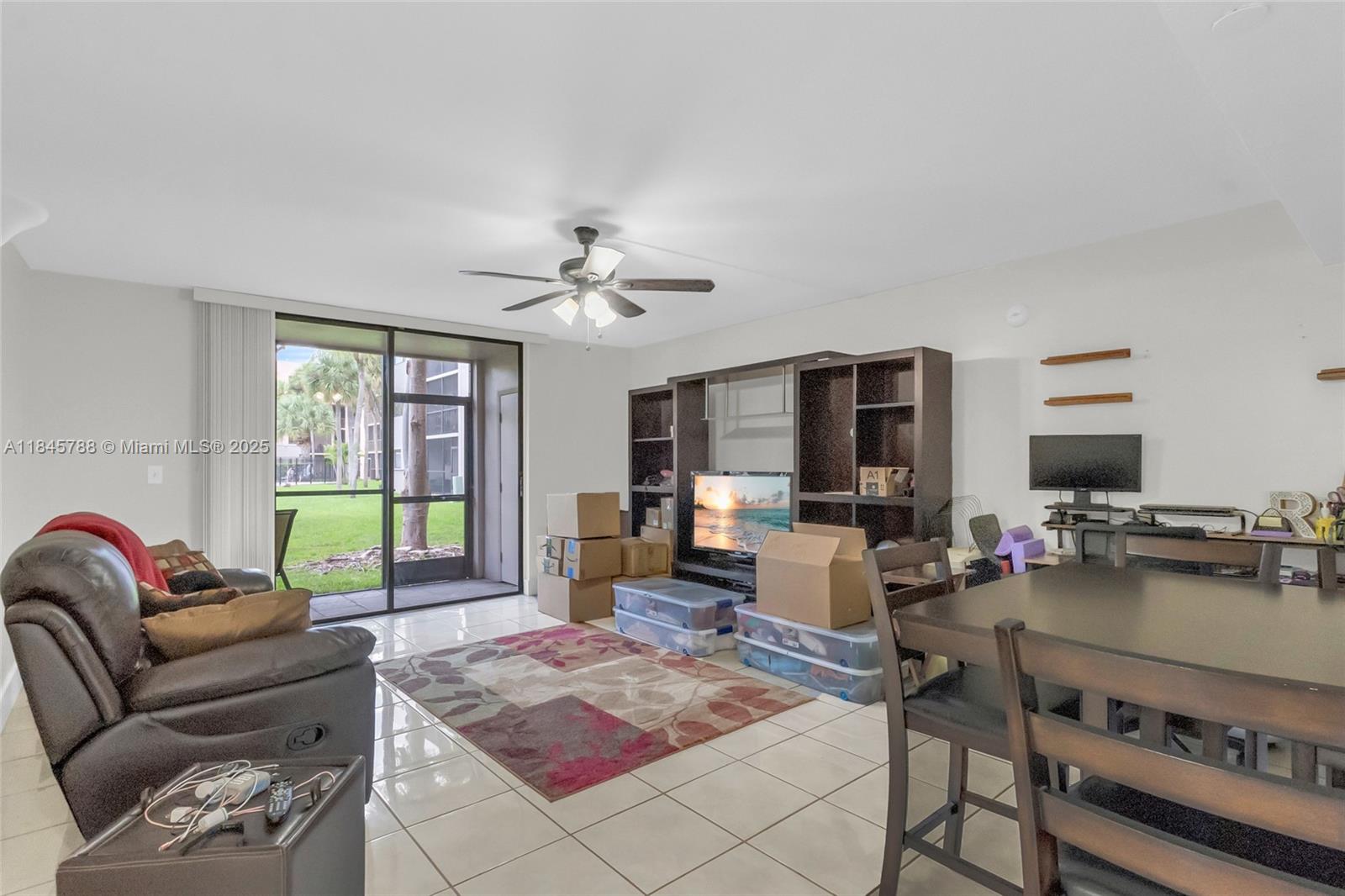 8760 Southwest 133rd Avenue Road, Unit 108 Miami, FL 33183 - Photo 4 of 39 a living room with furniture and a flat screen tv