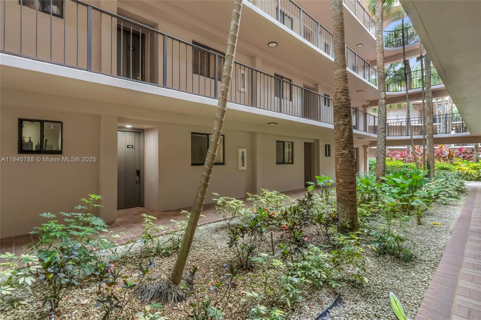 8760 Southwest 133rd Avenue Road, Unit 108 Miami, FL 33183 - Photo 9 of 39 a backyard of a house with plants and entryway