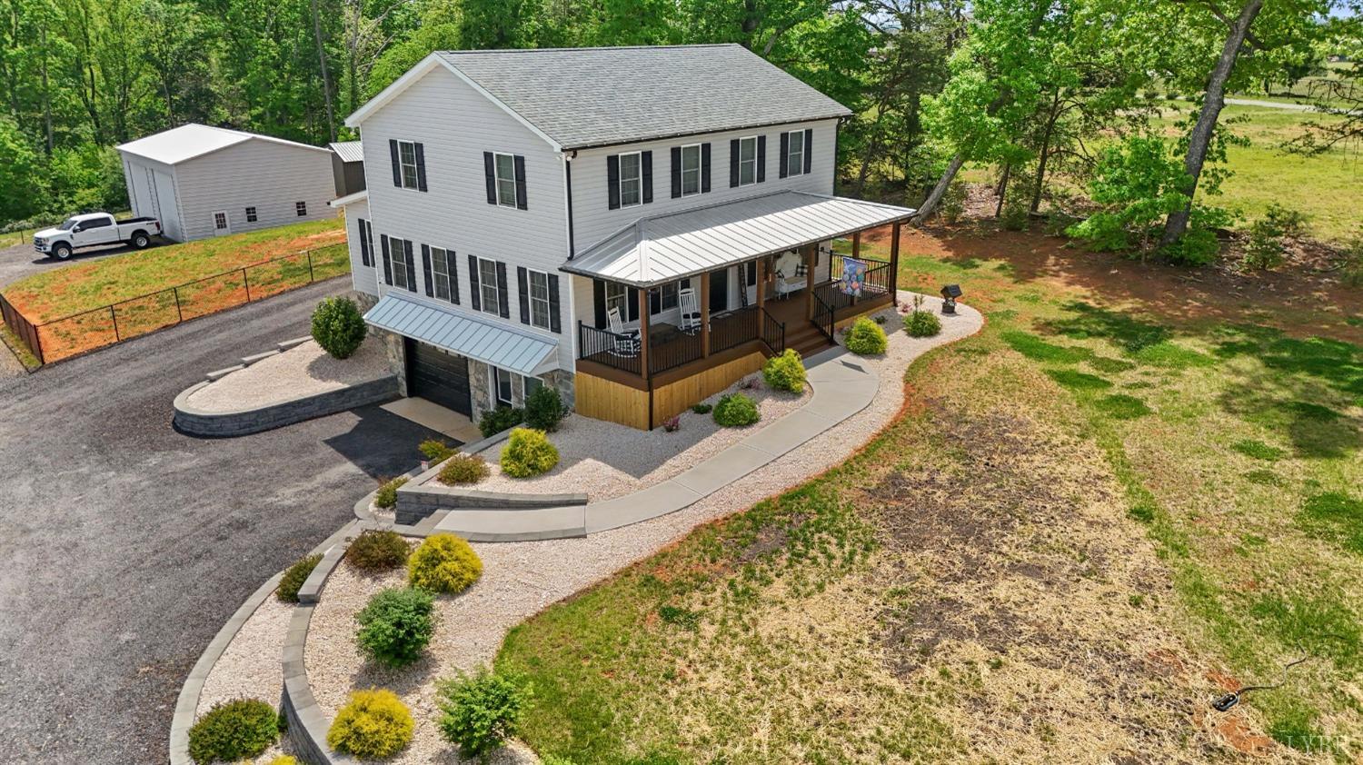 4607 Lowry Road Goode, VA 24556 - Photo 1 of 64 a aerial view of a house with swimming pool and sitting area