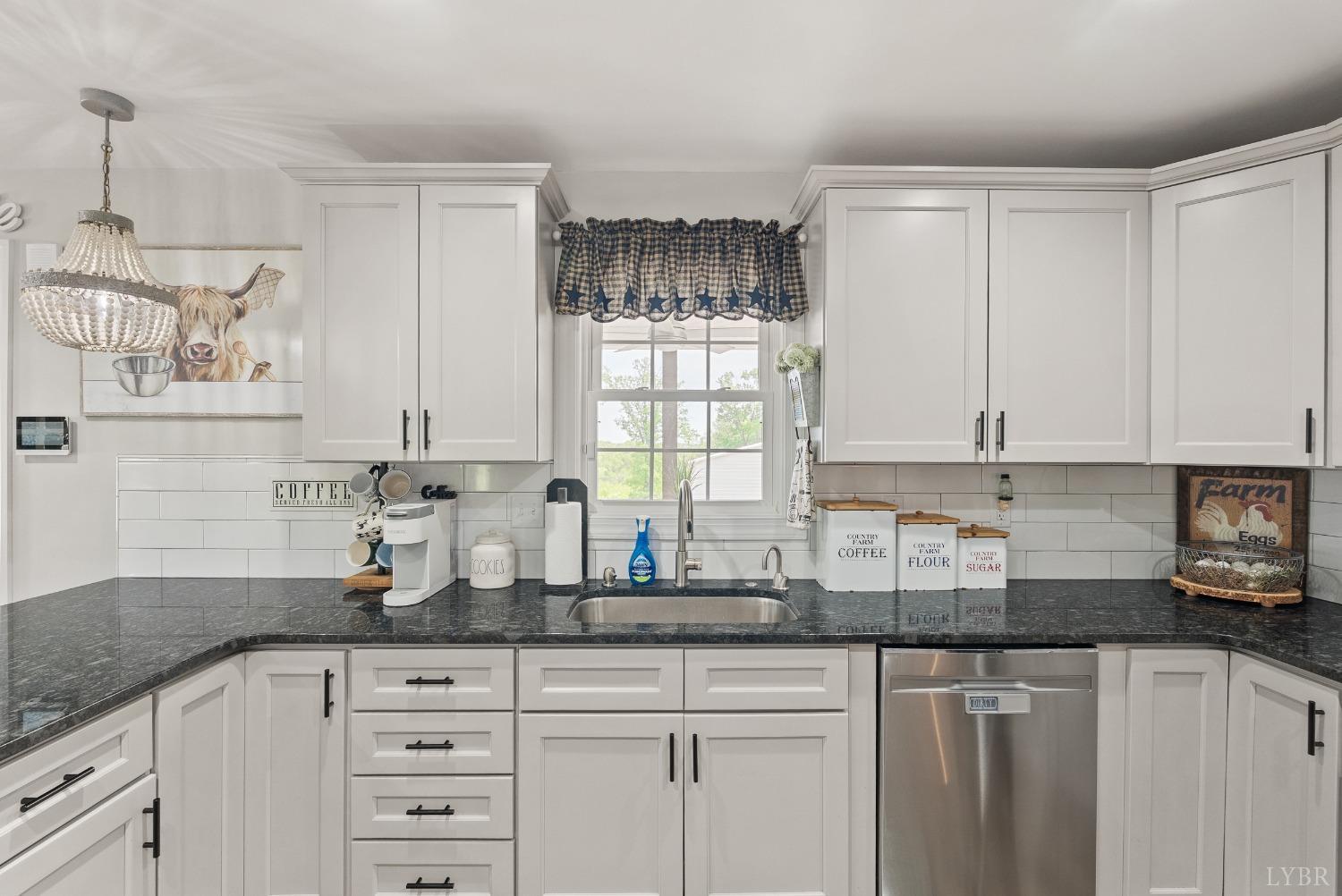 4607 Lowry Road Goode, VA 24556 - Photo 11 of 64 a kitchen with granite countertop white cabinets and white appliances