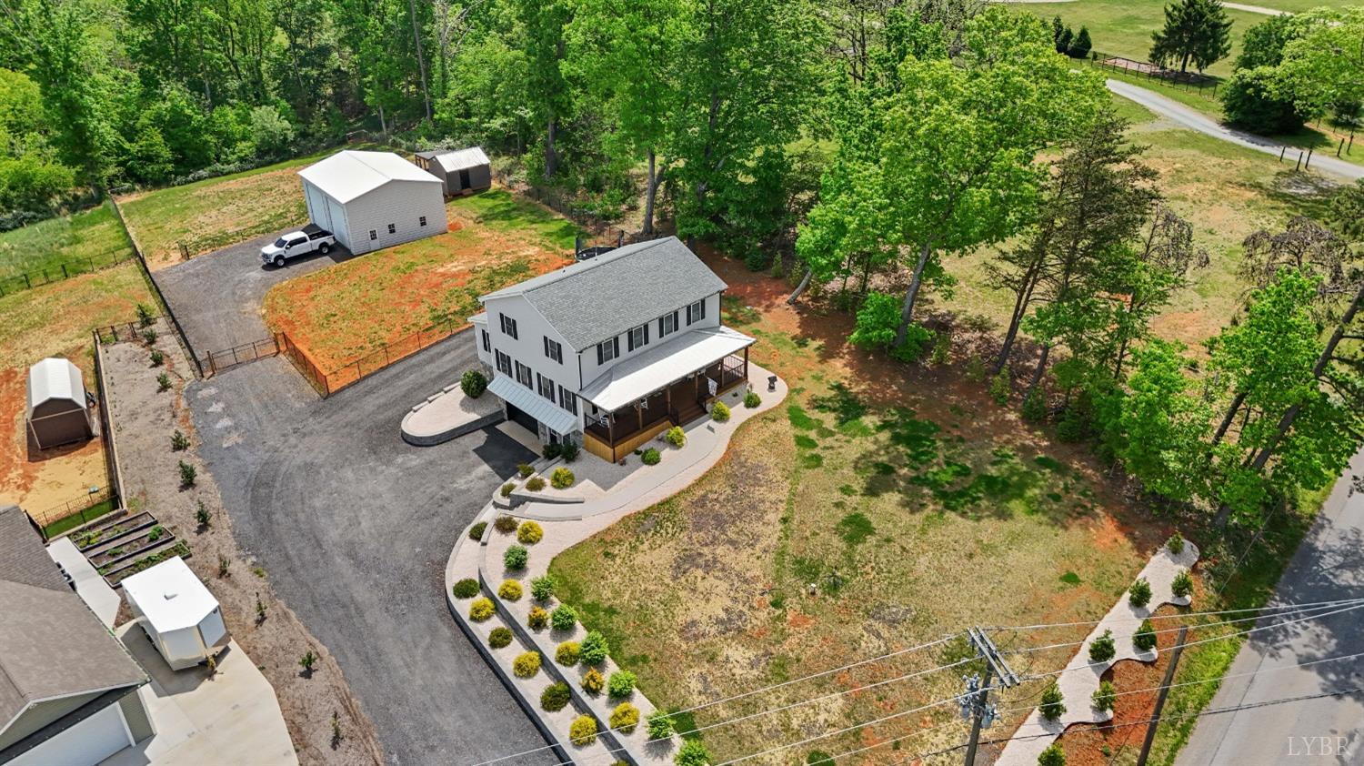 4607 Lowry Road Goode, VA 24556 - Photo 48 of 64 an aerial view of a house with a yard and trees