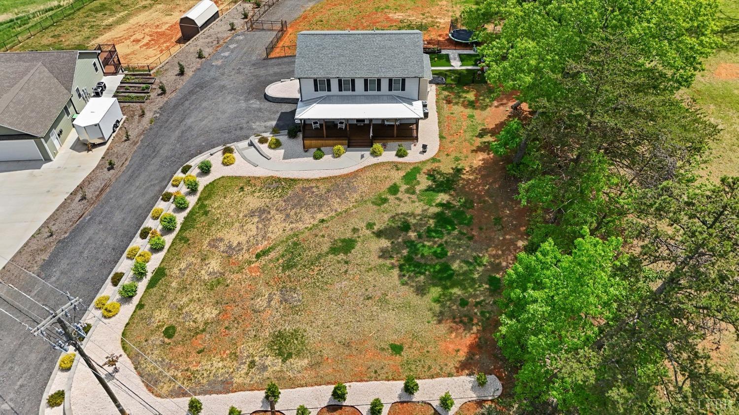 4607 Lowry Road Goode, VA 24556 - Photo 49 of 64 an aerial view of a house with swimming pool and large trees